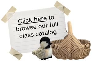 A paper sign that says "Click here to browse our full class catalog." A basket and a needle felted bird are in front of it.