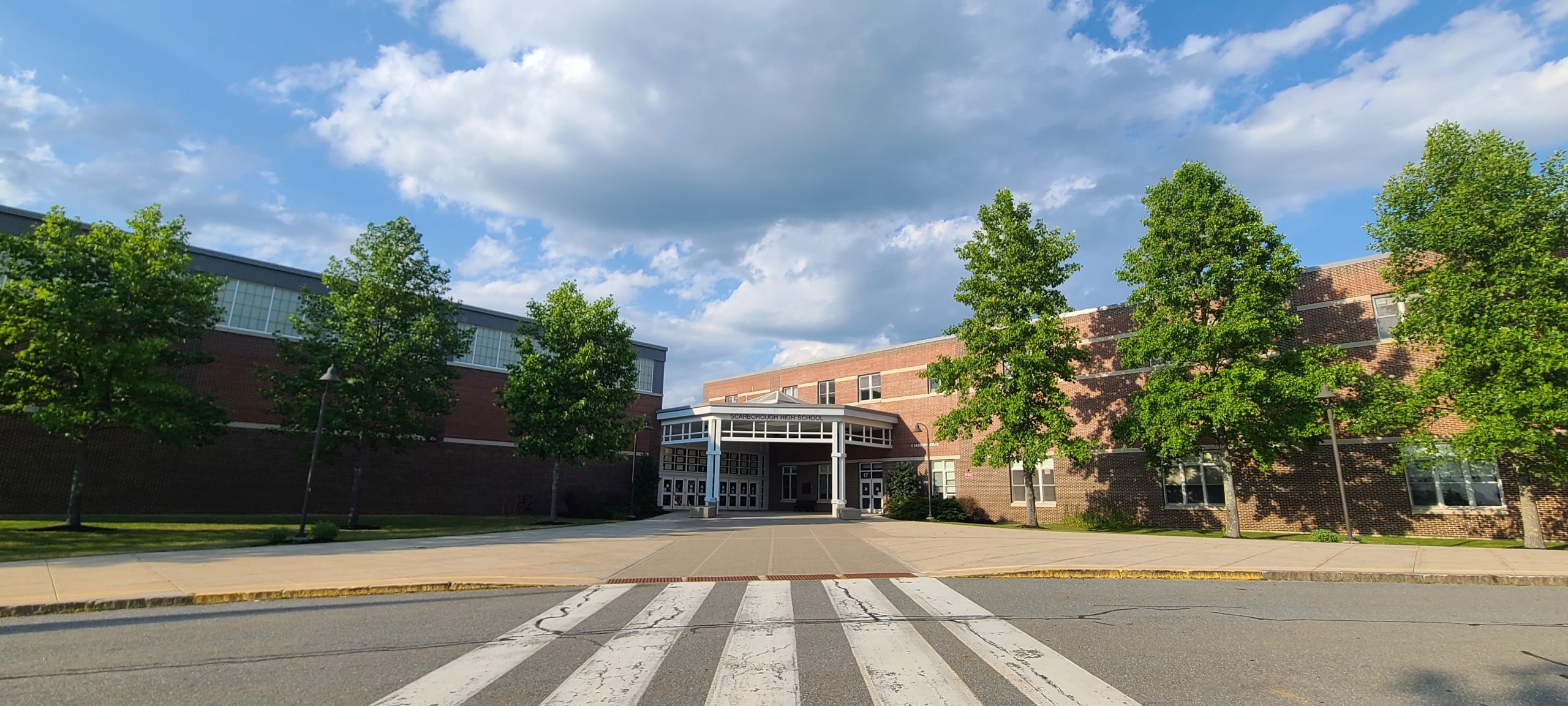 Photo of the front of Scarborough High School on a sunny day where the entrance to Scarborough Adult Ed is located. 
